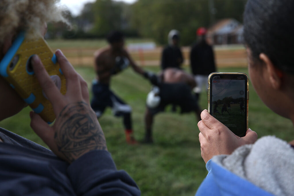 Pat Wilson, right, live streams a boxing match